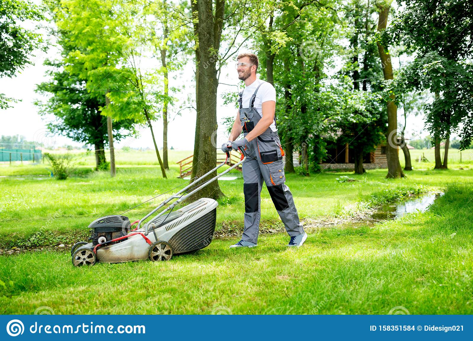 Gardener Equipped With Lawnmower On The Job Stock Photo ...